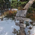 Trail junction in the snow.